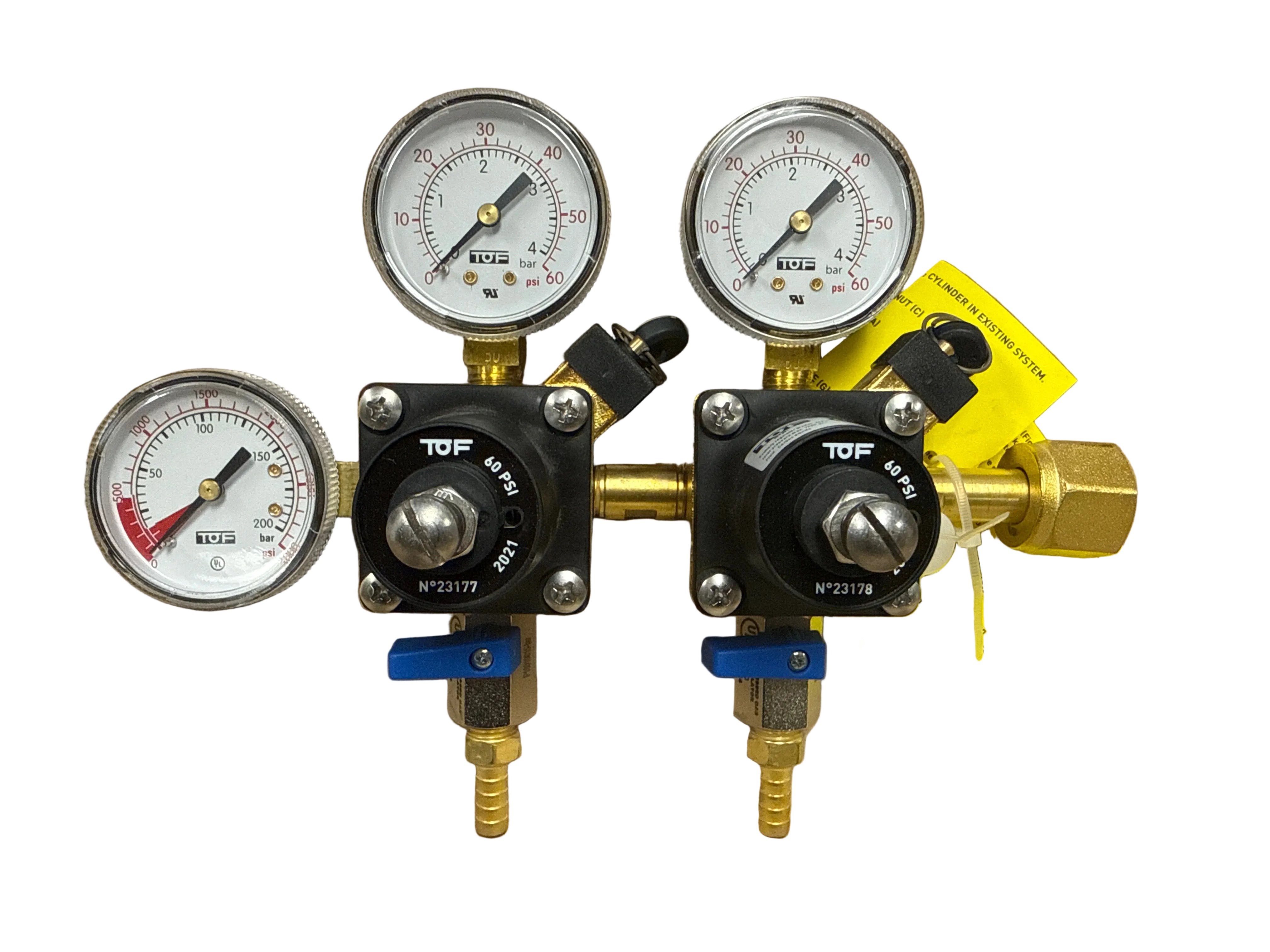 Two TUF pressure regulators with gauges on a brown background